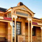 An old wooden house with a red roof.